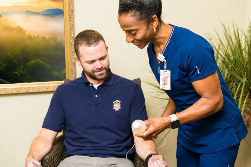 Nurse Teaching patient how to self administer home infusion