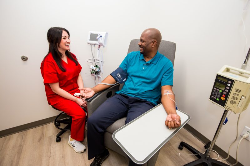 Intramed Plus nurse assisting a patient in a private infusion suite