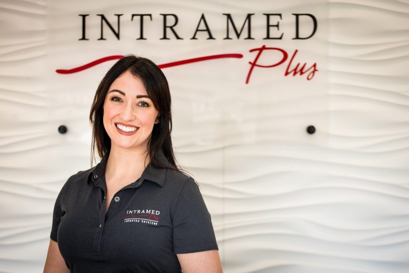 Female Intramed Plus employee looking into the camera
